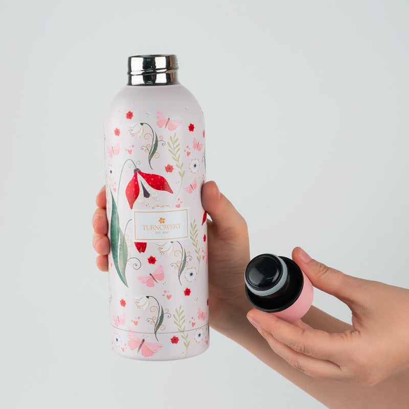 Zbliżenie na szczelny korek różowej butelki termicznej.