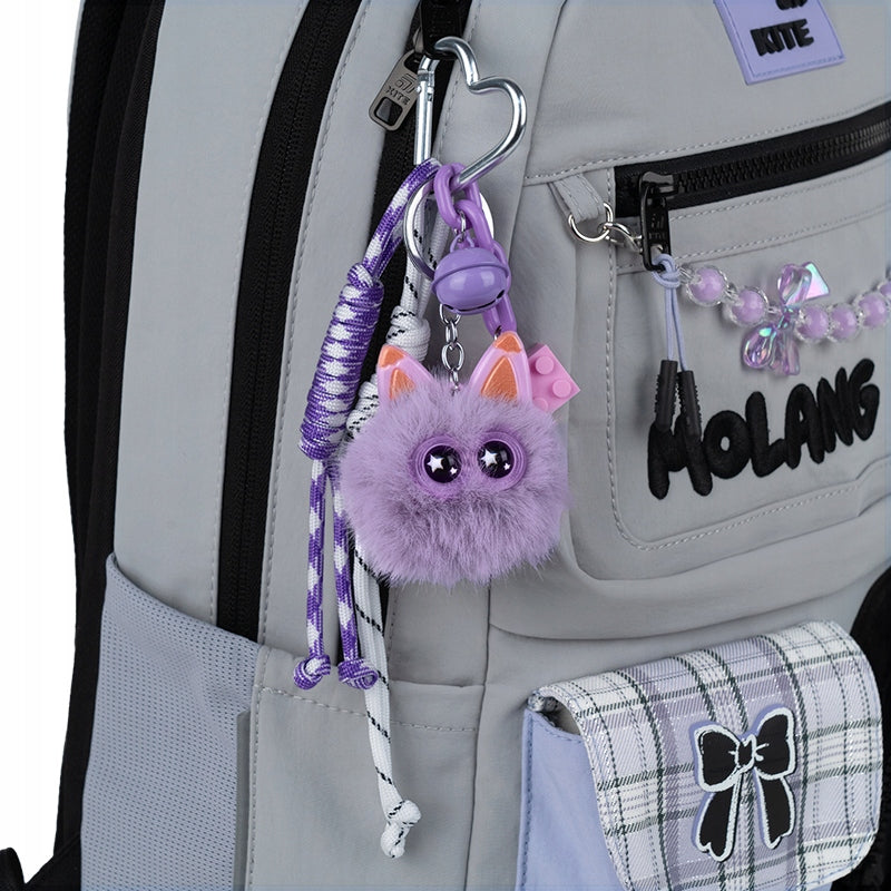 Zawieszka do plecaka Kite zamocowana przy suwaku – stylowa ozdoba streetwear.