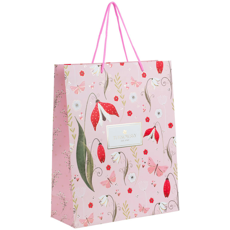 Widok z boku papierowej torby prezentowej Axent.