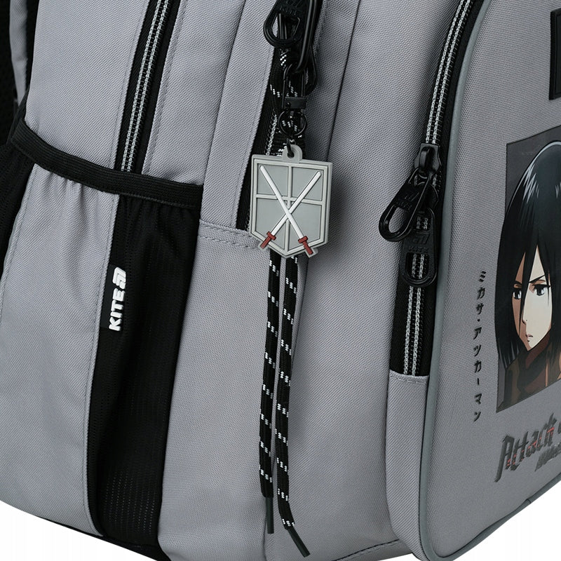 Zbliżenie na unikalną zawieszkę z motywem Attack on Titan przy suwaku.