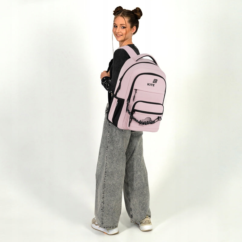 Nastolatka trzymająca plecak na jednym ramieniu.