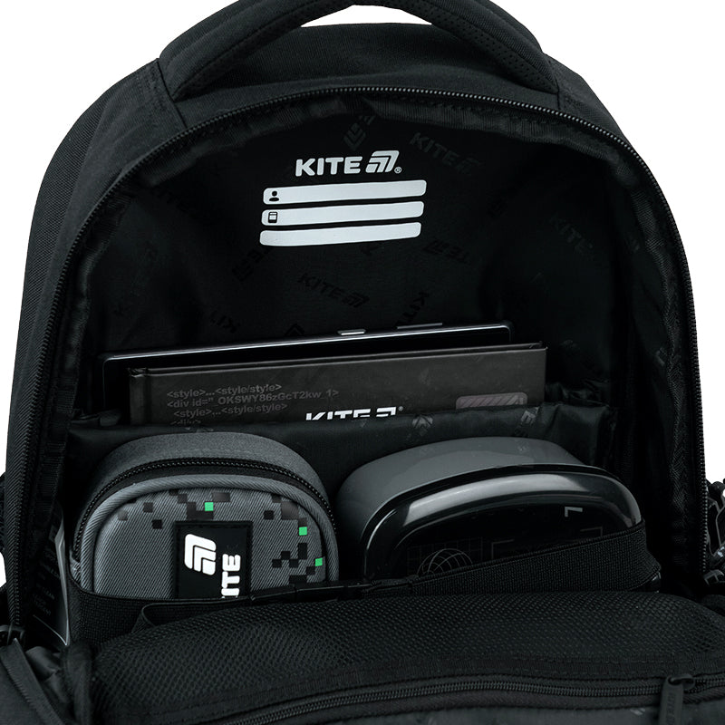 Wnętrze głównej komory z przegrodami na podręczniki i gumką mocującą.